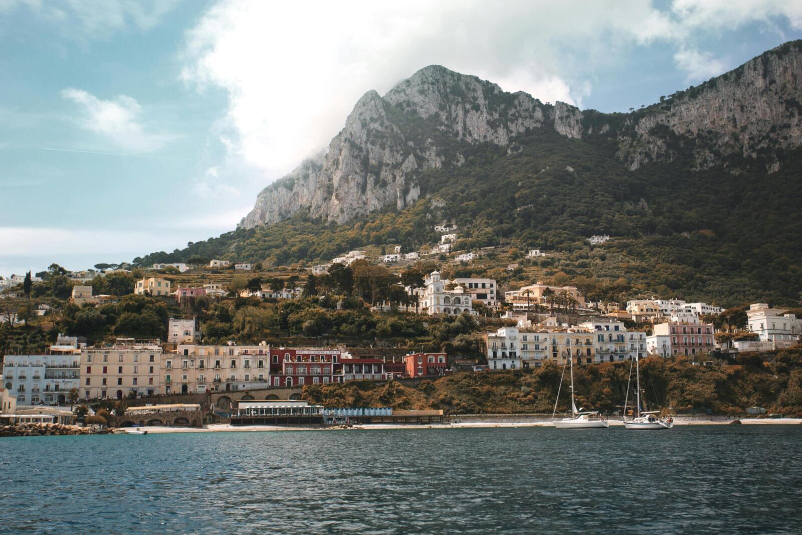 Breathtaking shot of Capri Island's coastal town with mountains and sea.