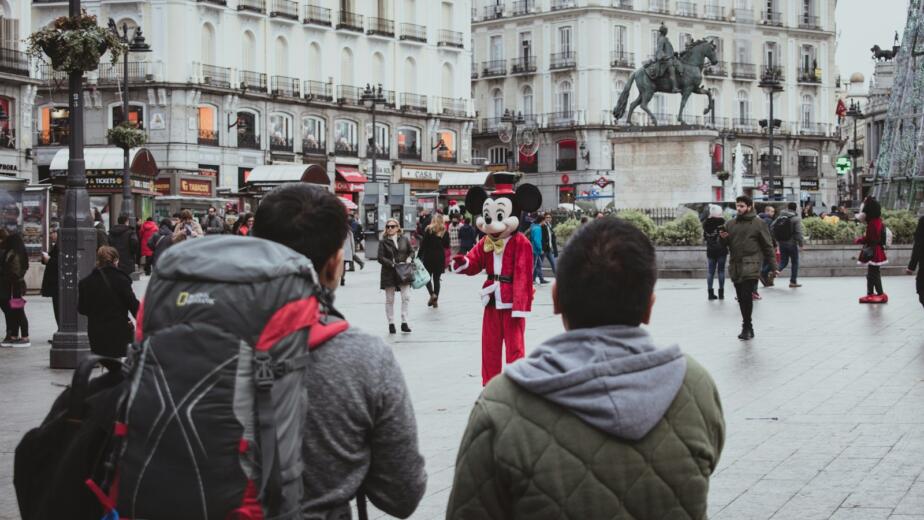 man and woman standing near white concrete building