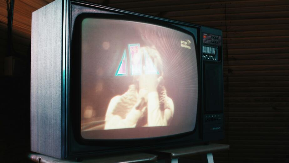 a television sitting on top of a step ladder