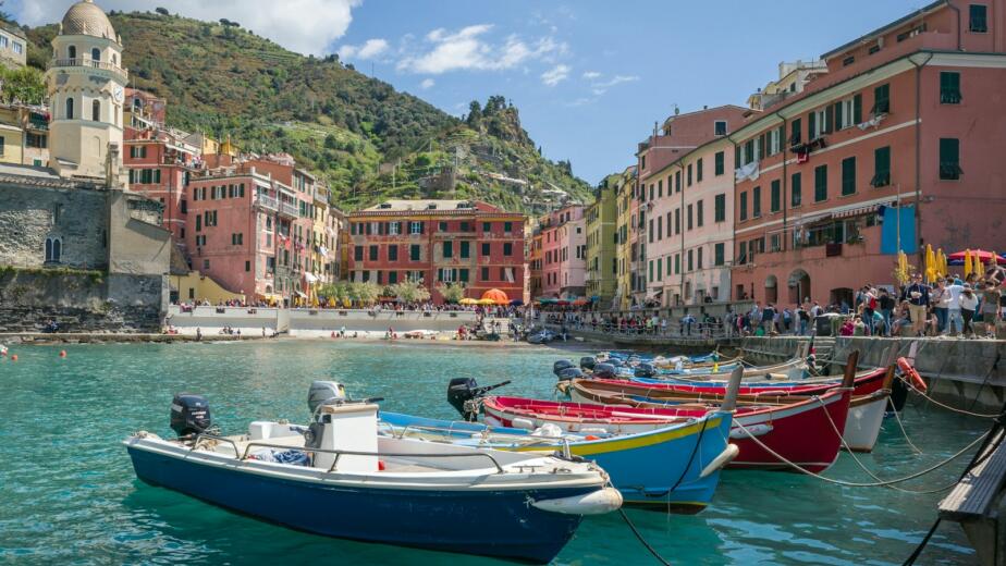 white and blue boat on water near buildings during daytime