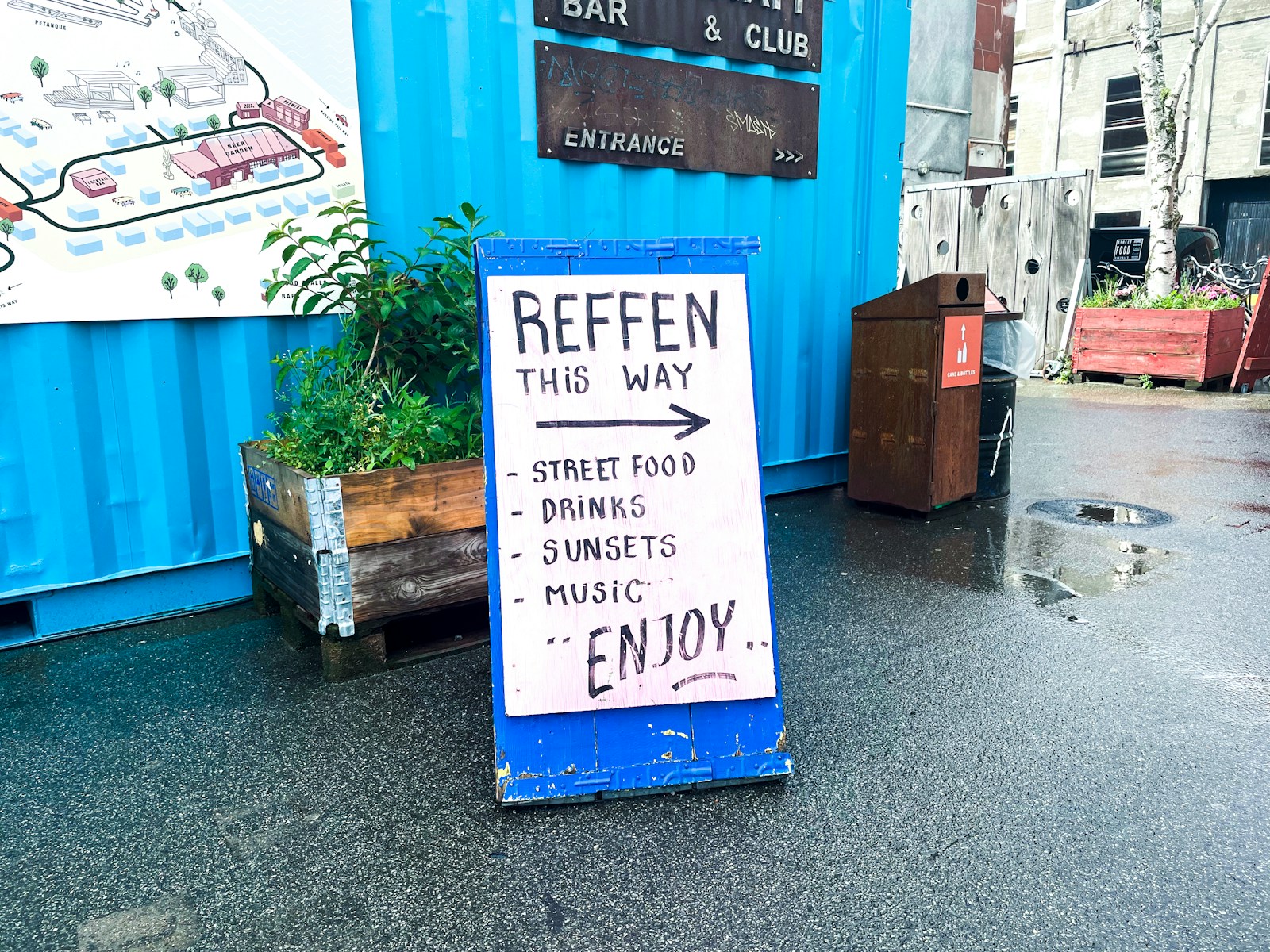 A sign that is sitting on the ground