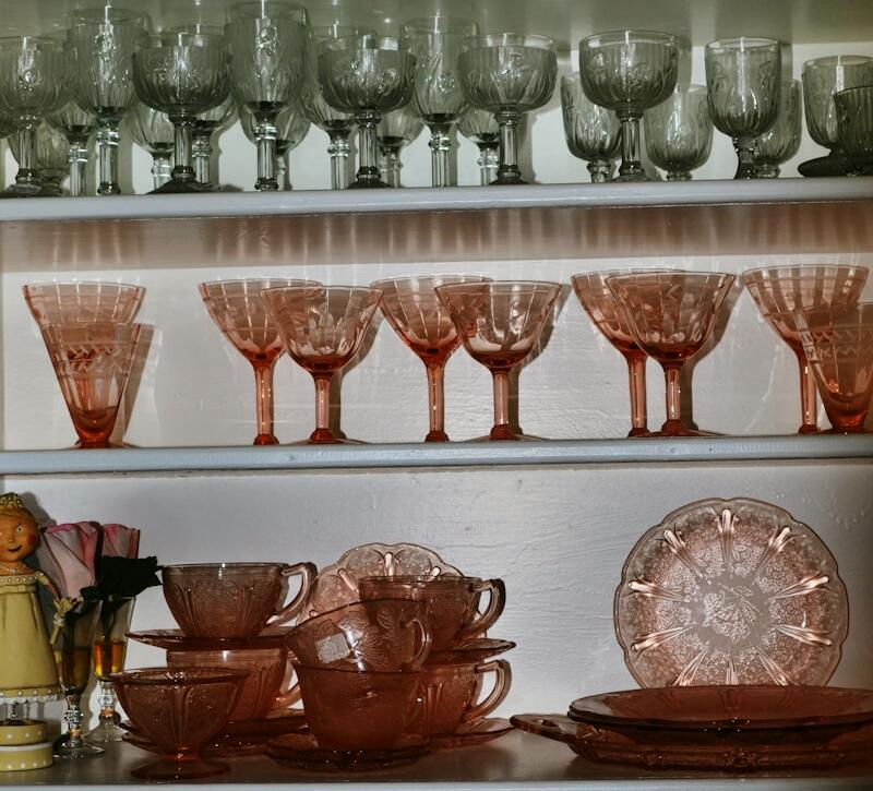 a shelf filled with lots of glasses and plates