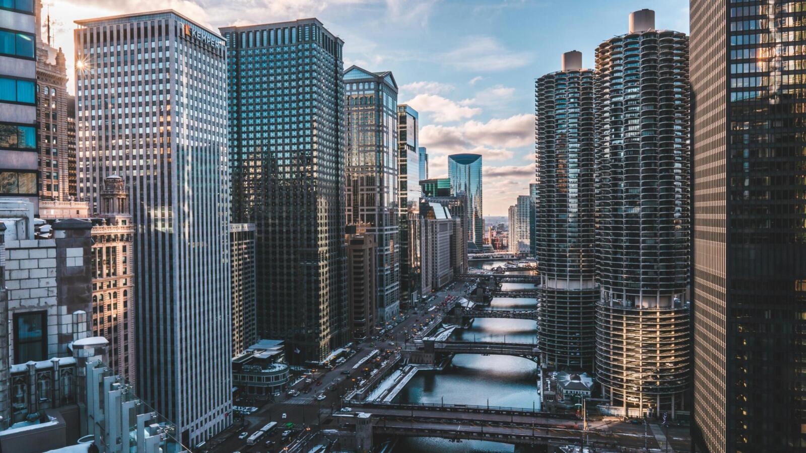 A breathtaking view of Chicago's iconic skyscrapers and waterway at day with a clear sky.