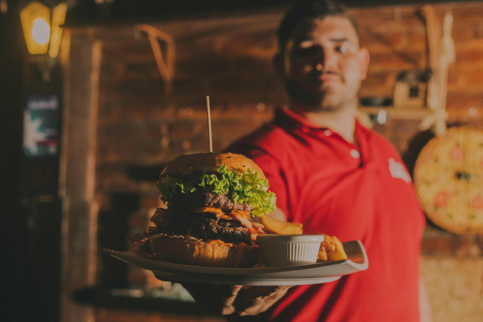 Delicious gourmet burger with fries served indoors at a restaurant in Brazil.