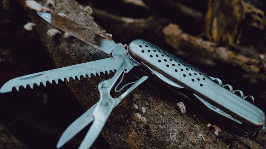 silver multi tool on brown rock